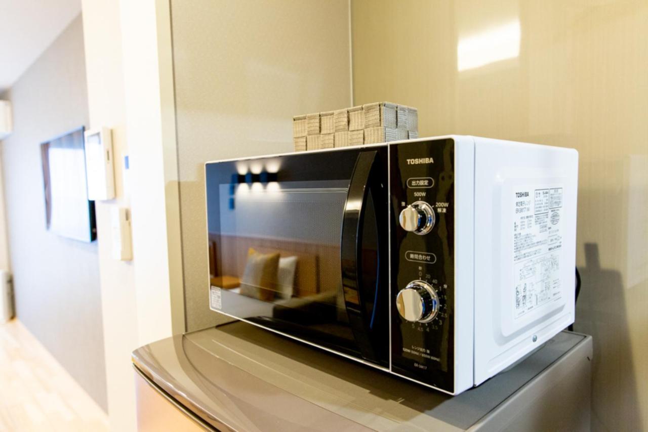 Grand Base Hiroshima Hikarimachi Aparthotel Bagian luar foto